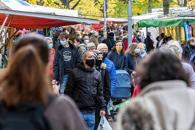 People wear protective masks as they shop at an outside market in the Neukoelln district during the second wave of the coronavirus pandemic on Oct. 27 in Berlin, Germany.
Credit:	Maja Hitij/Getty Images