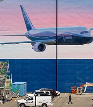 Caption:	A worker walks outside of a Boeing Co. facility in Everett, Washington on May 27. Boeing Co. unveiled the first and deepest of its planned job cuts, saying it would notify 6,770 employees in the U.S. this week that their positions would be eliminated.
Credit:	David Ryder/Bloomberg/Getty Images