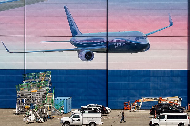Caption:	A worker walks outside of a Boeing Co. facility in Everett, Washington on May 27. Boeing Co. unveiled the first and deepest of its planned job cuts, saying it would notify 6,770 employees in the U.S. this week that their positions would be eliminated.
Credit:	David Ryder/Bloomberg/Getty Images