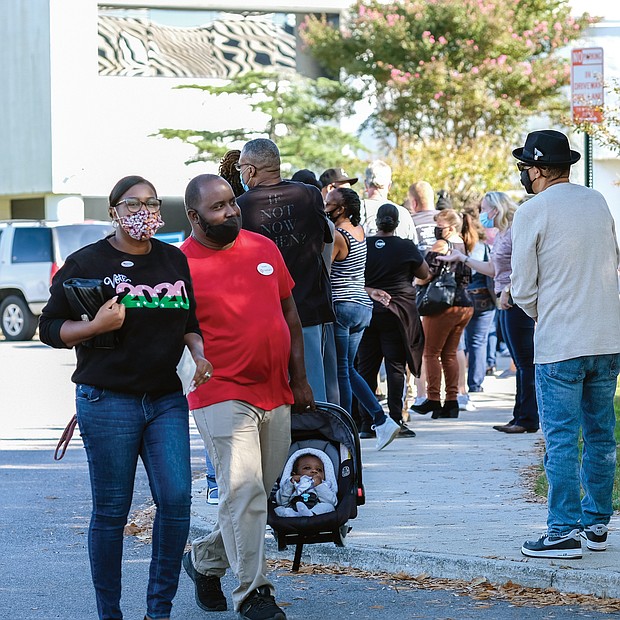 Four-month-old Greyson White gets his first taste of voting as he accompanies his parents, Kindal and George White, when they cast ballots last Saturday at the eastern Henrico Government Center, 3820 Nine Mile Road. the deadline for early, in-person voting
is Saturday, Oct. 31.