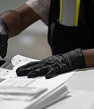 In this Sept. 3, 2020, file photo, a worker prepares absentee ballots for mailing at the Wake County Board of Elections in Raleigh, N.C. A federal appeals court has ruled that North Carolina can accept absentee ballots for more than a week after Election Day as long as they were postmarked by Nov. 3./Credit:	Gerry Broome/AP