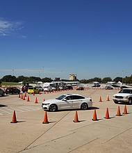 Voters in cars line up at a drive-through mail ballot drop-off site at NRG Stadium on October 7, 2020 in Houston, Texas. Gov. Gregg Abbott issued an executive order limiting each county to one mail ballot drop-off site due to the pandemic./Credit:	Go Nakamura/Getty Images