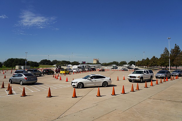 Voters in cars line up at a drive-through mail ballot drop-off site at NRG Stadium on October 7, 2020 in Houston, Texas. Gov. Gregg Abbott issued an executive order limiting each county to one mail ballot drop-off site due to the pandemic./Credit:	Go Nakamura/Getty Images