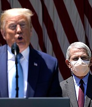 President Donald Trump is flanked by Dr. Anthony Fauci, director of the National Institute of Allergy and Infectious Diseases while speaking about coronavirus vaccine development in the Rose Garden of the White House on May 15, 2020 in Washington, DC./Credit:	Drew Angerer/Getty Images