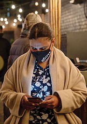 Mayoral candidate Kim B. Gray looks at early election results Tuesday night at her watch party at a restaurant in Carytown.