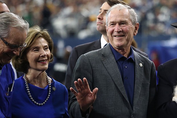 Former President George W. Bush and former First Lady Laura Bush are seen here attending the NFL game between the Dallas Cowboys and the Green Bay Packers at AT&T Stadium.
Credit:	Ronald Martinez/Getty Images