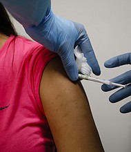 A health worker injects a person during clinical trials for a Covid-19 vaccine at Research Centers of America in Hollywood, Florida on Sept. 9.
Credit:	Eva Marie Uzcategui/Bloomberg/Getty Images