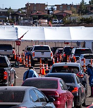 Texas has now surpassed one million Covid-19 infections since the start of the pandemic, according to data from Johns Hopkins University. In this photo, medical workers wearing personal protective equipment register people in vehicles at a Covid-19 drive-thru testing site in El Paso, Texas, on Nov. 9.
Credit:	Joel Angel Juarez/Bloomberg/Getty Images