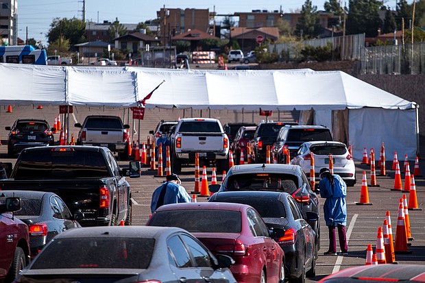 Texas has now surpassed one million Covid-19 infections since the start of the pandemic, according to data from Johns Hopkins University. In this photo, medical workers wearing personal protective equipment register people in vehicles at a Covid-19 drive-thru testing site in El Paso, Texas, on Nov. 9.
Credit:	Joel Angel Juarez/Bloomberg/Getty Images
