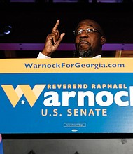The Rev. Raphael Warnock, a Democratic candidate for the U.S. Senate, speaks Nov. 3 during a rally in Atlanta.