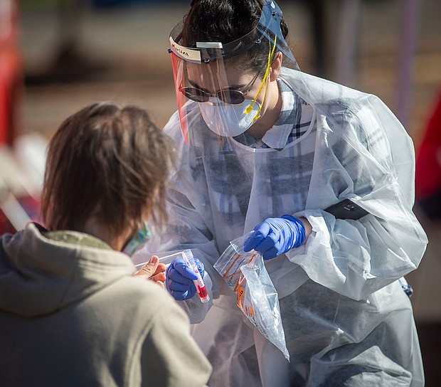 Marissa Gallegos with Medical Teams Northwest takes a swab from a person who was accessing COVID-19 testing at the Lane County Fairgrounds in Eugene, Oregon on October, 8, 2020.
Credit:	Andy Nelson/Imagn/USA Today