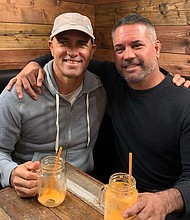 John Shimooka (right) poses for a photo with Kelly Slater.
Credit: From John Shimooka/Instagram