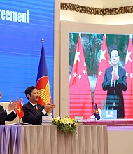 Vietnam's Prime Minister Nguyen Xuan Phuc (L) and Minister of Industry and Trade Tran Tuan Anh (R) during the virtual signing ceremony for the Regional Comprehensive Economic Partnership (RCEP) in Hanoi, Vietnam, 15 November 2020.
Credit: Luong Thai Linh/EPA-EFE/Shutterstock