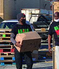 Black Men United partnered with Christmas in the Wards to provide Personal Protective Equipment as well as food during events across the city in October and early November. Photo by Tia Carol Jones