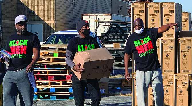 Black Men United partnered with Christmas in the Wards to provide Personal Protective Equipment as well as food during events across the city in October and early November. Photo by Tia Carol Jones