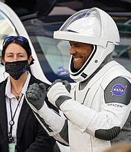 NASA astronaut Victor Glover reacts last Sunday to family members as he leaves the Operations and Checkout Building at the Kennedy Space Center with fellow crew members for a six-month mission to the International Space Station.