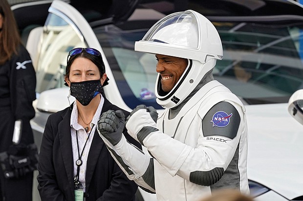 NASA astronaut Victor Glover reacts last Sunday to family members as he leaves the Operations and Checkout Building at the Kennedy Space Center with fellow crew members for a six-month mission to the International Space Station.