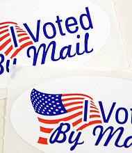 Stickers that read "I Voted By Mail" sit on a table waiting to be stuffed into envelopes by absentee ballot election workers  at the Mecklenburg County Board of Elections office in Charlotte, NC on September 4, 2020.
Credit:	LOGAN CYRUS/AFP/Getty Images
