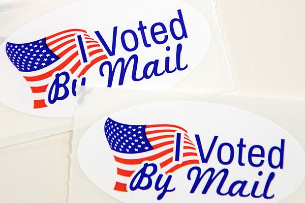 Stickers that read "I Voted By Mail" sit on a table waiting to be stuffed into envelopes by absentee ballot election workers  at the Mecklenburg County Board of Elections office in Charlotte, NC on September 4, 2020.
Credit:	LOGAN CYRUS/AFP/Getty Images