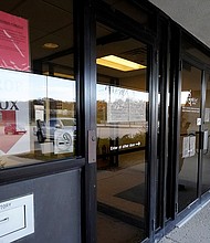 A woman checks information as information signs are displayed at IDES (Illinois Department of Employment Security) WorkNet center in Arlington Heights, Illinois on November 5, 2020.
Credit:	Nam Y. Huh/AP