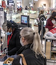 JCPenney employees checkout customers while following COVID-19 guidelines on November 27, 2020.
Credit: Stephen Zenner/SOPA Images/Shutterstock