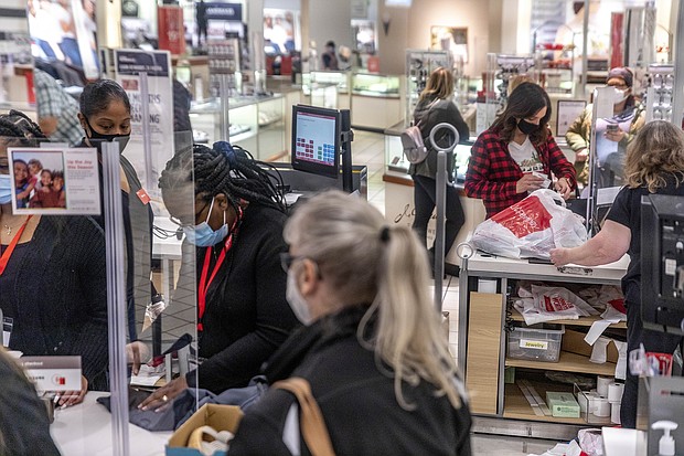JCPenney employees checkout customers while following COVID-19 guidelines on November 27, 2020.
Credit: Stephen Zenner/SOPA Images/Shutterstock