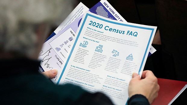A person holds census information at a February 22, 2020, event in Queens, New York.