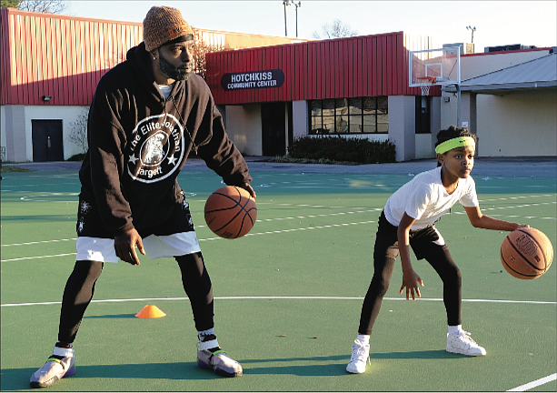 Chrishona Wilson, 8, works on her basketball skills with Coach Jonathan Hargett at Hotchkiss Field Community Center in North Side last Saturday. The youngster, who attended practice with her stepmother, played last year for the South Side Ducks, a youth team under the auspices of the city Department of Parks, Recreation and Community Facilities.