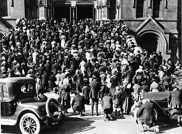 The congregation of the Cathedral of Saint Mary of the Assumption praying on the steps, where they gathered to hear mass and pray during the influenza pandemic of 1918.
Credit:	Hulton Archive/Getty Images