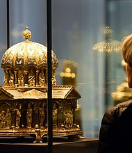 A visitor looks at the the cupola reliquary (Kuppelreliquar) of the so-called "Welfenschatz" (Guelph Treasure) displayed at the Kunstgewerbemuseum (Museum of Decorative Arts) in Berlin.
Credit:	Tobias Schwarz/AFP/Getty Images