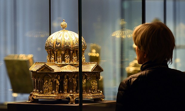 A visitor looks at the the cupola reliquary (Kuppelreliquar) of the so-called "Welfenschatz" (Guelph Treasure) displayed at the Kunstgewerbemuseum (Museum of Decorative Arts) in Berlin.
Credit:	Tobias Schwarz/AFP/Getty Images