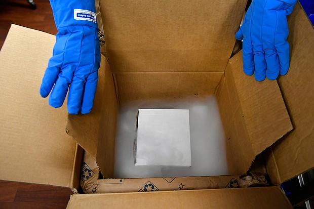 Vail Health Hospital pharmacy technician Rob Brown gets ready to take mock Covid-19 vaccines out of a thermal shipping container.
Credit:	Helen H. Richardson/Denver Post/Getty Images