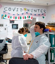 Healthcare worker Gabriel Cervera (C) takes a moment between seeing patients in the Covid-19 ward at United Memorial Medical Center in Houston, Texas on December 4, 2020.
Credit:	Mark Felix/AFP/Getty Images