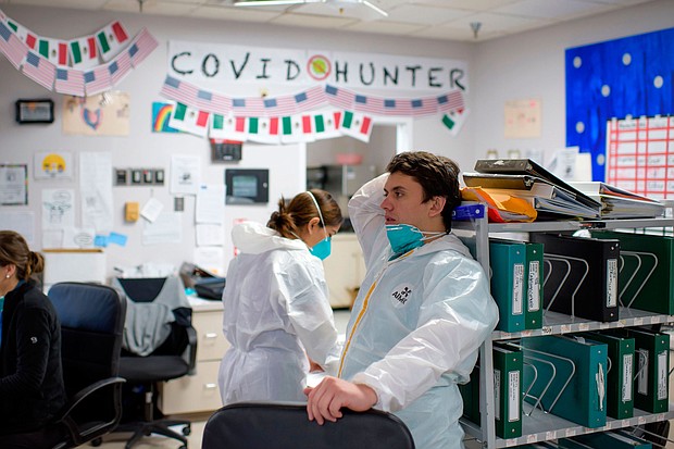 Healthcare worker Gabriel Cervera (C) takes a moment between seeing patients in the Covid-19 ward at United Memorial Medical Center in Houston, Texas on December 4, 2020.
Credit: Mark Felix/AFP/Getty Images