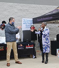 Radio personality “Miss Community” Clovia Lawrence of Urban One gets a big surprise last Saturday when Gov. Ralph S. Northam, center, and Lt. Gov. Justin E. Fairfax, left, show up during her 17th Annual Toy Drive outside the Walmart store on Sheila Lane in South Side and present her with proclamations honoring her 30 years of community work. The surprise presentation was organized by Christopher J. Woody of the Woody Foundation. Ms. Lawrence started the toy drive in 2004 to assist working families who couldn’t afford gifts for their children during the holiday season. Since then, more than 60,000 donated toys have been given to Richmond area families. Even as she was being honored, Ms. Lawrence was busy encouraging shoppers to purchase and donate toys for youngsters in need.