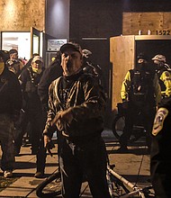 Members of the Proud Boys yell in front of a hotel during a protest on Dec. 12, in Washington, DC.
Credit:	Stephanie Keith/Getty Images