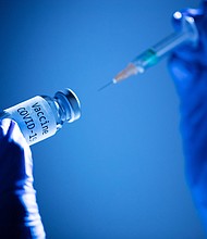 This picture taken on Nov. 17, 2020 shows a syringe and a bottle reading "Vaccine Covid-19."
Credit:	JOEL SAGET/AFP/Getty Images