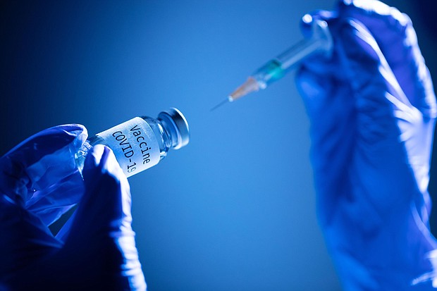This picture taken on Nov. 17, 2020 shows a syringe and a bottle reading "Vaccine Covid-19."
Credit:	JOEL SAGET/AFP/Getty Images