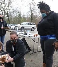 Like people, furry friends need annual checkups to make sure they are healthy, too. On Dec. 5, two nonprofit organizations, Salem’s Light and the Street Dog Coalition, offered a free veterinary clinic for pets at Forest Hill Park. The clinic drew all types and sizes of pets. Shakirah Abdal, listens as veterinarian Dr. Justin Jones details his findings after examining her 12-year-old pit bull terrier, Bella, who was being held by veterinary assistant Rachel Ring. Bella’s follow-up appointment for X-rays and dental care at Dr. Jones’ office will be covered by Salem’s Light, an outreach, education, advocacy and spay and neuter organization.