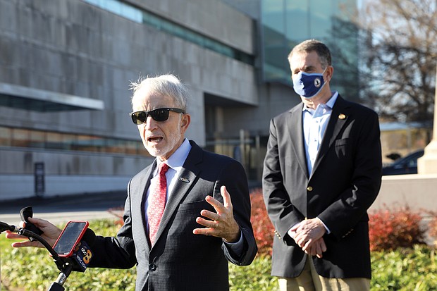 Alex Nyerges, left, director and chief executive officer of the Virginia Museum of Fine Arts, talks about the proposal of Gov. Ralph S. Northam, right, to pump $25 million into transforming historical sites, including $11 million to reimagine Monument Avenue. Under the plan, unveiled last Friday outside the museum, the VMFA would lead the public effort to redesign it.