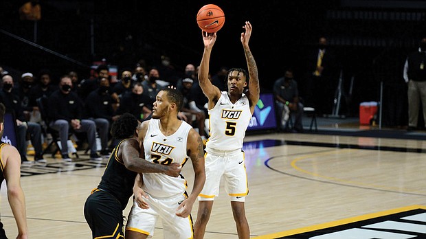 Virginia Commonwealth University guard Nah’Shon “Bones” Hyland, No. 5 jersey, is open to launch another 3-pointer at a recent game.