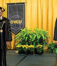 Virginia Commonwealth University President Michael Rao, left, practices social distancing with Solomon Workneh of Arlington. Mr. Workneh served as the inaugural student speaker at VCU’s 2020 winter commencement held online last Saturday.