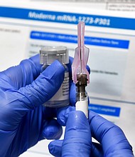 In this July 27, 2020, file photo, a nurse prepares a shot as a study of a possible COVID-19 vaccine, developed by the National Institutes of Health and Moderna Inc., gets underway in Binghamton, N.Y. The U.S. is poised to give the green light as early as Friday, Dec. 18, to a second COVID-19 vaccine, a critical new weapon against the surging coronavirus. Doses of the vaccine developed by Moderna Inc. and the National Institutes of Health will give a much-needed boost to supplies as the biggest vaccination effort in the nation's history continues.
Credit: Hans Pennink/AP