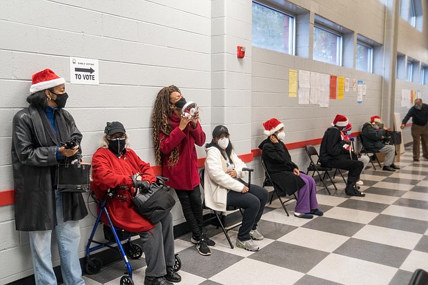 People wait in line for early voting at C.T. Martin Natatorium and Recreation Center on December 14, 2020 in Atlanta, Georgia. Early voting started today in Georgia for the runoff election for the Georgia Senate seats. The race is between Republican incumbents David Perdue and Kelly Loeffler and Democratic candidates John Ossoff and Raphael Warnock.
Credit:	Megan Varner/Getty Images