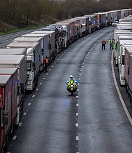 Lorries are stacked along the M20 motorway as the border to France is closed on December 22, 2020 in Sellindge, United Kingdom. Nearly 1000 lorries remained stacked up in Kent as drivers waited for a resumption of travel from the port of Dover to France. On Sunday, France abruptly halted freight and passenger travel from the UK over concerns about the UK's surging covid-19 cases and a new variant of the virus.
Credit: Chris J Ratcliffe/Getty Images
