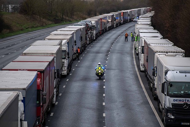 Lorries are stacked along the M20 motorway as the border to France is closed on December 22, 2020 in Sellindge, United Kingdom. Nearly 1000 lorries remained stacked up in Kent as drivers waited for a resumption of travel from the port of Dover to France. On Sunday, France abruptly halted freight and passenger travel from the UK over concerns about the UK's surging covid-19 cases and a new variant of the virus.
Credit:	Chris J Ratcliffe/Getty Images