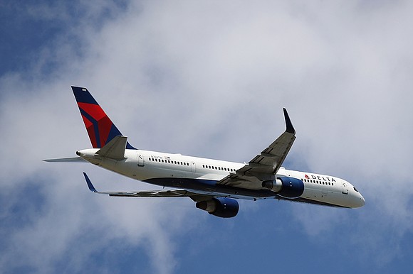 Two passengers on a Delta flight bound for Atlanta opened a cabin door and activated the slide to exit the …