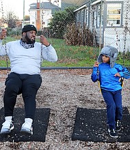 Clarence Thornton and his 5-year-old son, Chauncey, spend quality time together Tuesday at Hotchkiss Field in North Side. The youngster, a kindergartener at Richmond Prep,
is close to his father and loves spending time outdoors with him. When the two are together, Mr. Thornton says he offers his son lessons on manners and how to play with other youngsters. The proud dad said young Chauncey received straight As on his first report card.