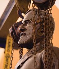 Workers delicately remove the statue of Confederate Gen. Robert E. Lee from the U.S. Capitol following a recommendation last week by a state commission that it be replaced with a statue of the late teen civil rights activist Barbara R. Johns. The Lee statue was one of two representing Virginia in the U.S. Capitol and among 13 located in the Crypt of the Capitol, representing the 13 original colonies. At the request of the commission, the Virginia Museum of History and Culture in Richmond has accepted ownership of the statue.