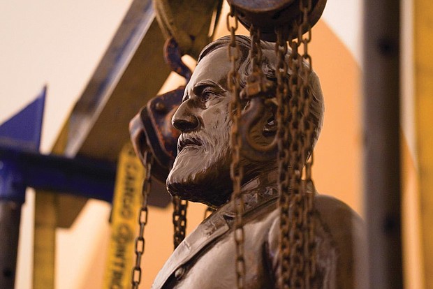 Workers delicately remove the statue of Confederate Gen. Robert E. Lee from the U.S. Capitol following a recommendation last week by a state commission that it be replaced with a statue of the late teen civil rights activist Barbara R. Johns. The Lee statue was one of two representing Virginia in the U.S. Capitol and among 13 located in the Crypt of the Capitol, representing the 13 original colonies. At the request of the commission, the Virginia Museum of History and Culture in Richmond has accepted ownership of the statue.